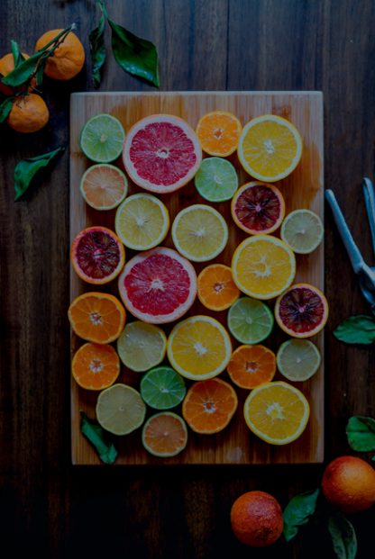 Variety of citrus on chopping board poster