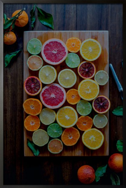 Variety of citrus on chopping board poster