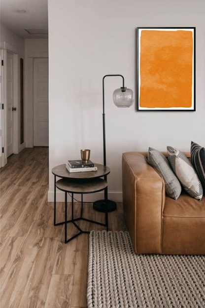 Textured orange watercolor poster in interior