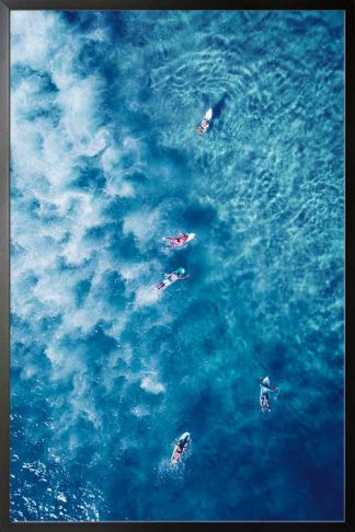 Surfing on a blue water poster in a black frame