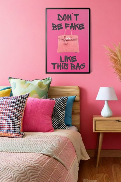 Don't Be Fake Poster in black frame inside the bedroom with white lamps and pillows