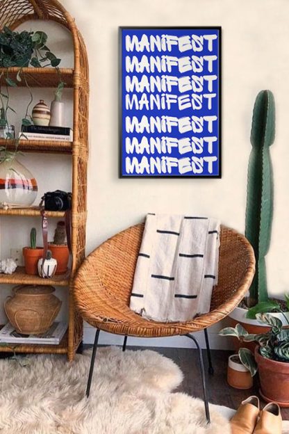 Manifest Typography Poster in black frame inside the room with native weaved drawer and chairs