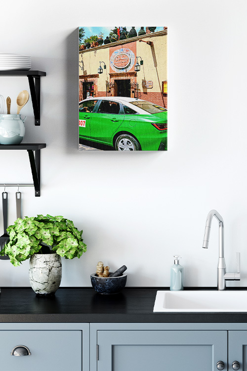 A canvas art print wall decor of a green car in front of the entrance to Tío Lucas Restaurante Bar, a popular spot in San Miguel de Allende, Mexico